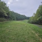 Panoramic view of a lush green golf course at Stone Mountain Golf Club. Smooth