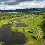 Panoramic view of a lush green golf course at Stone Ridge Golf Club. Smooth