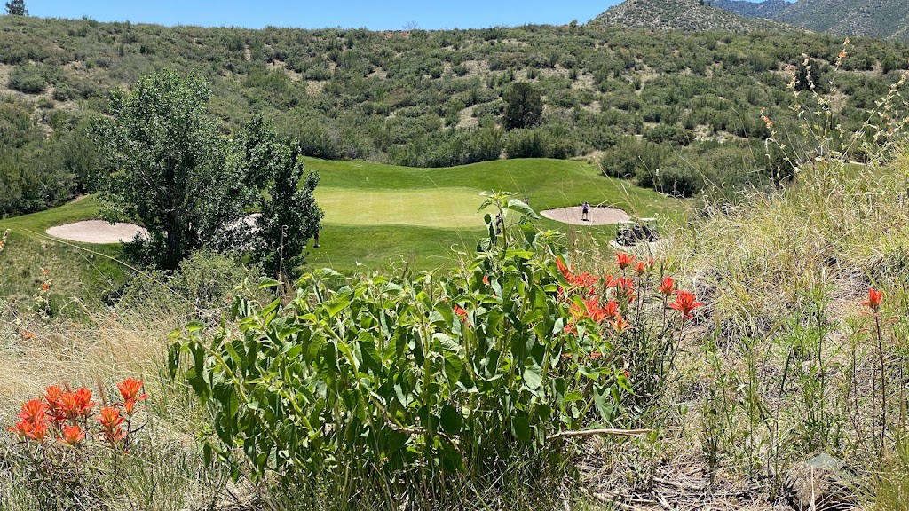 Panoramic view of a lush green golf course at Stone Ridge Golf Course. Smooth