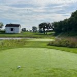 green grass with the flag in the hole.