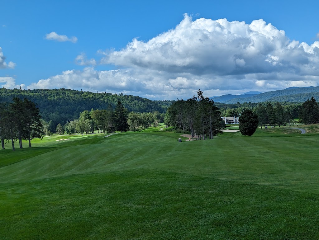 Panoramic view of a lush green golf course at Stowe Country Club. Smooth