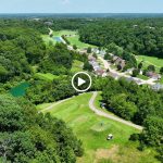 Panoramic view of a lush green golf course at Sugar Creek Golf Course & Banquet Center. Smooth