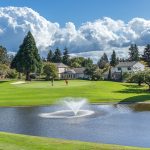 Panoramic view of a lush green golf course at Summerfield Golf Course. Smooth