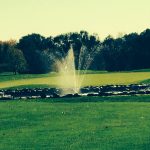 Panoramic view of a lush green golf course at Summerland Golf Course. Smooth