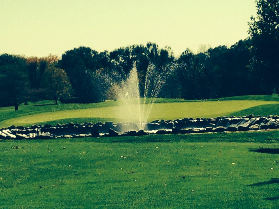 Panoramic view of a lush green golf course at Summerland Golf Course. Smooth