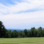 Panoramic view of a lush green golf course at Summit Spring Golf Course & Mary's Irish Pub. Smooth