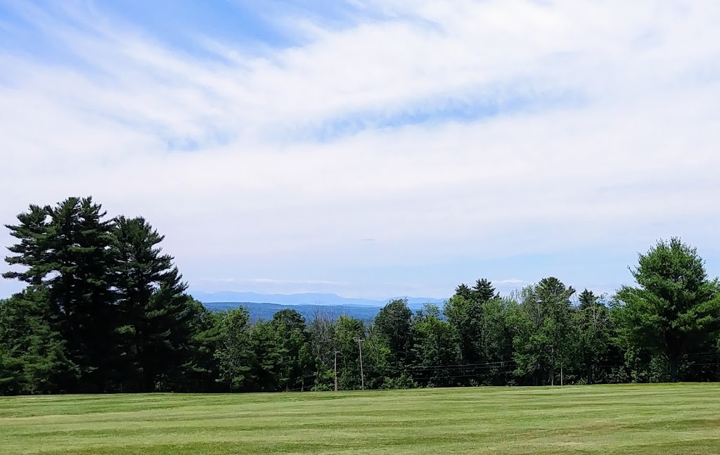 Panoramic view of a lush green golf course at Summit Spring Golf Course & Mary's Irish Pub. Smooth