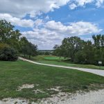 Panoramic view of a lush green golf course at Sun Valley Golf Course. Smooth