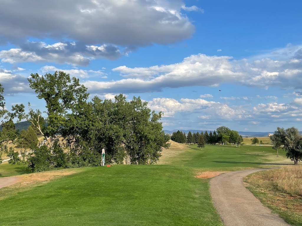 Panoramic view of a lush green golf course at Sundance Country Club. Smooth