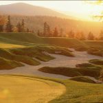 Panoramic view of a lush green golf course at Sunday River Golf Club. Smooth