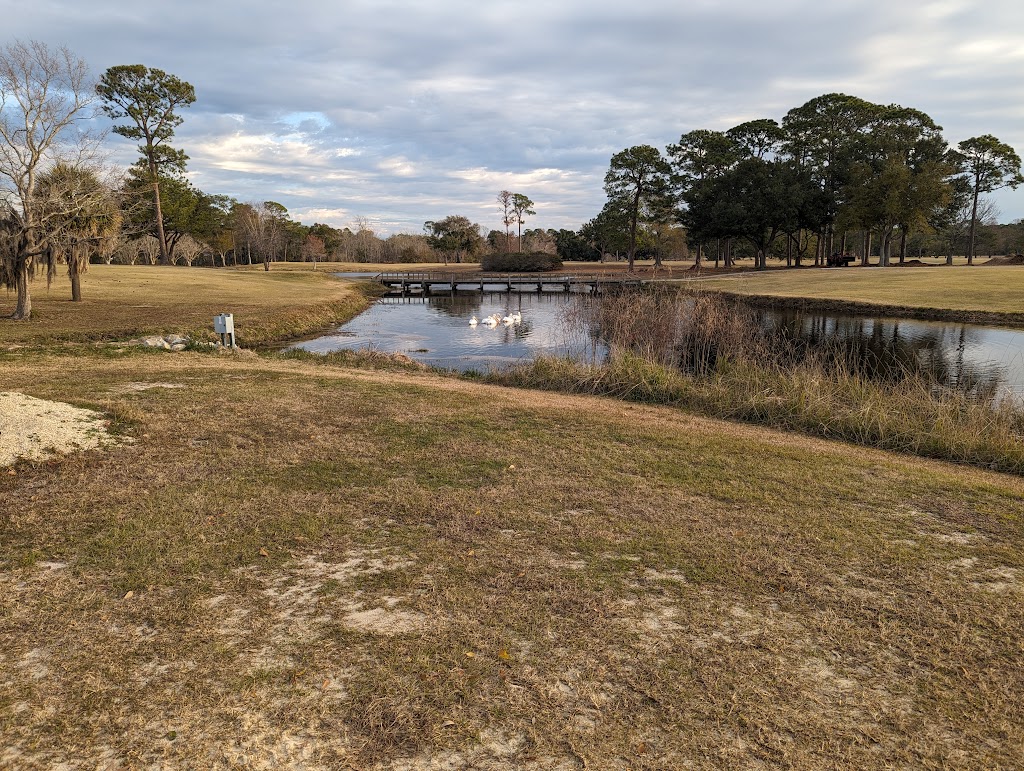 Panoramic view of a lush green golf course at Sunkist Country Club Bar & Grill. Smooth