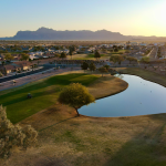 Panoramic view of a lush green golf course at Sunland Springs Golf Club. Smooth