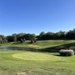 Panoramic view of a lush green golf course at Sunrise Golf. Smooth