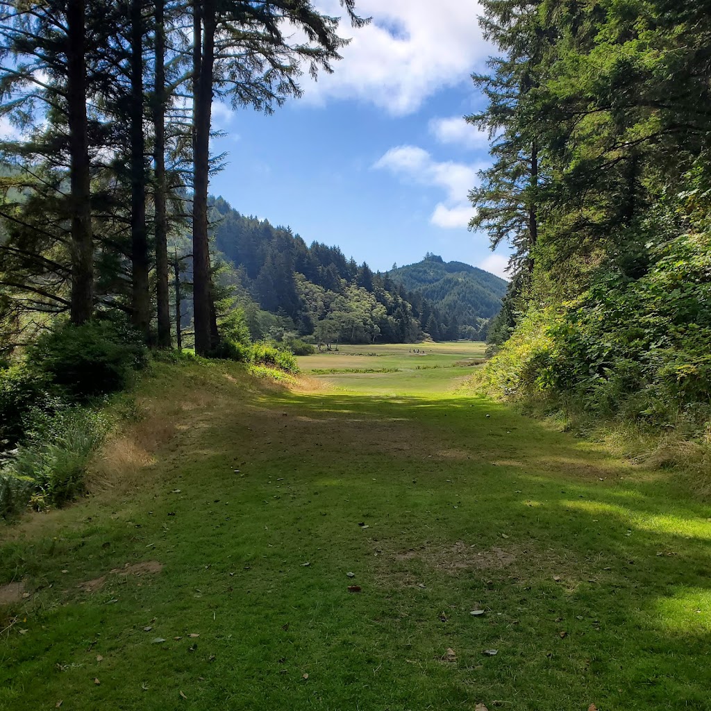 Panoramic view of a lush green golf course at Sunset Bay Golf Course. Smooth