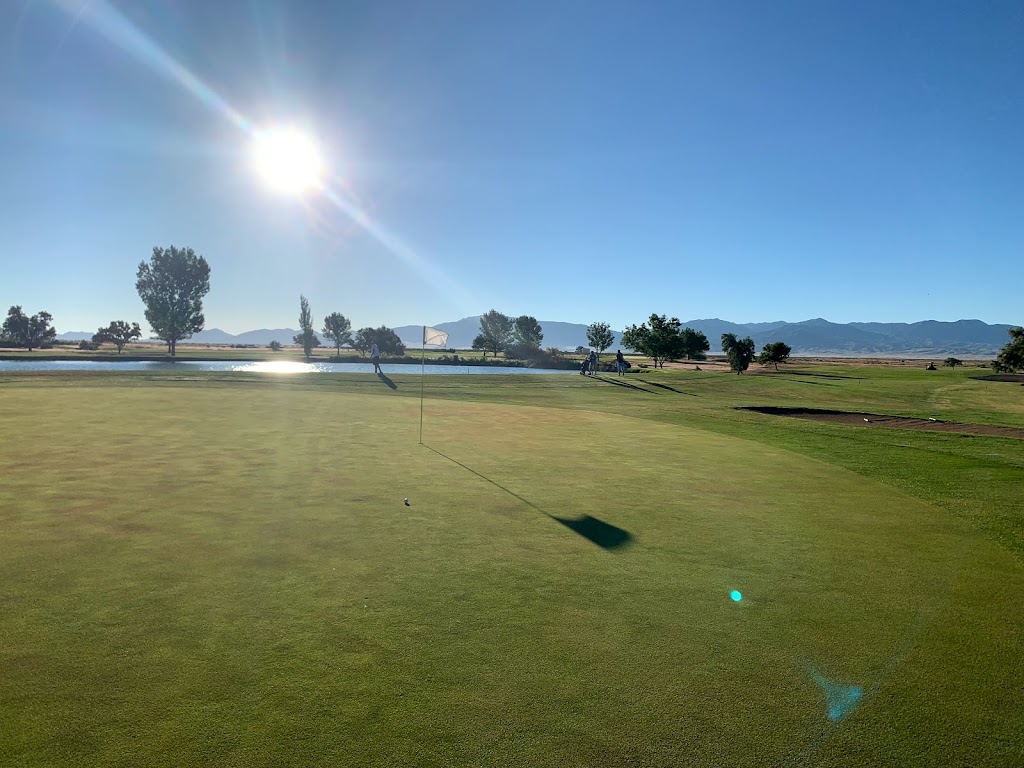 Panoramic view of a lush green golf course at Sunset View Golf Course. Smooth