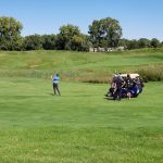 green grass with the flag in the hole.