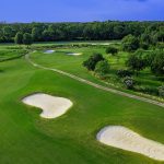 Panoramic view of a lush green golf course at Tamahka Trails Golf Course. Smooth