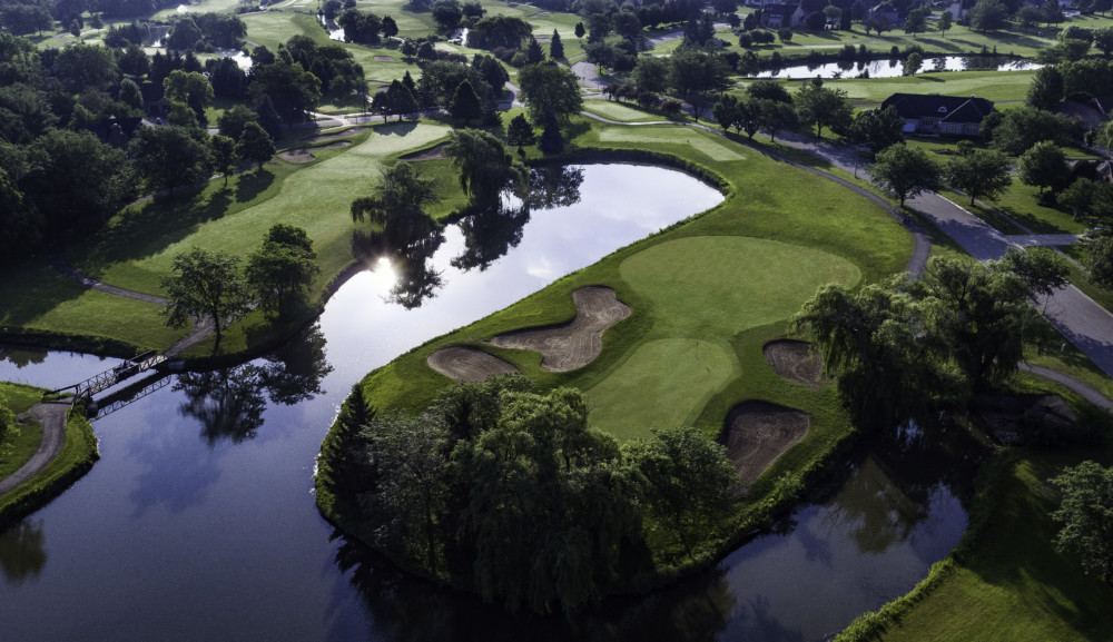 Panoramic view of a lush green golf course at Tamarack Golf Club. Smooth