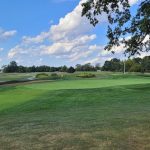 Panoramic view of a lush green golf course at Tanglewood Golf Course. Smooth