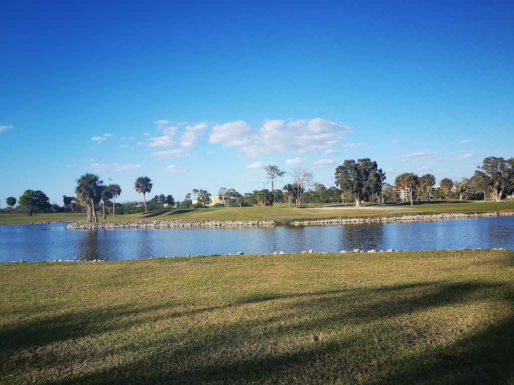 Panoramic view of a lush green golf course at Tarpon Springs Golf Course. Smooth