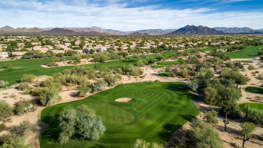 Panoramic view of a lush green golf course at Tatum Ranch Golf Club. Smooth