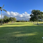 Panoramic view of a lush green golf course at Ted Makalena Golf Course. Smooth