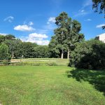 Panoramic view of a lush green golf course at Tekoa Country Club. Smooth