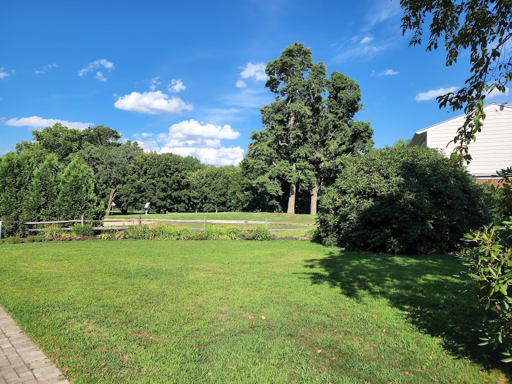 Panoramic view of a lush green golf course at Tekoa Country Club. Smooth