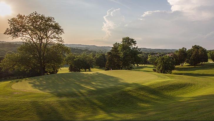 Panoramic view of a lush green golf course at Temple Hills Country Club. Smooth