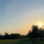 Panoramic view of a lush green golf course at Terrace Hills Golf Course. Smooth