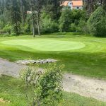 Panoramic view of a lush green golf course at Terrace Lakes Resort. Smooth