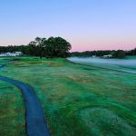 Panoramic view of a lush green golf course at The Bath Golf Club. Smooth