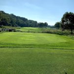 Panoramic view of a lush green golf course at The Bluffs At The National Golf Club. Smooth