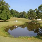 Panoramic view of a lush green golf course at The Bluffs Golf and Sports Resort. Smooth