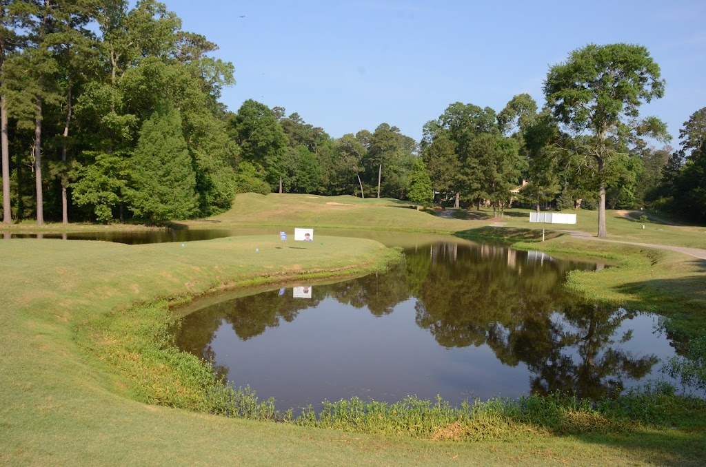 Panoramic view of a lush green golf course at The Bluffs Golf and Sports Resort. Smooth