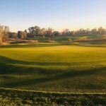 Panoramic view of a lush green golf course at The Bridges at Beresford Golf Course and Community Center. Smooth