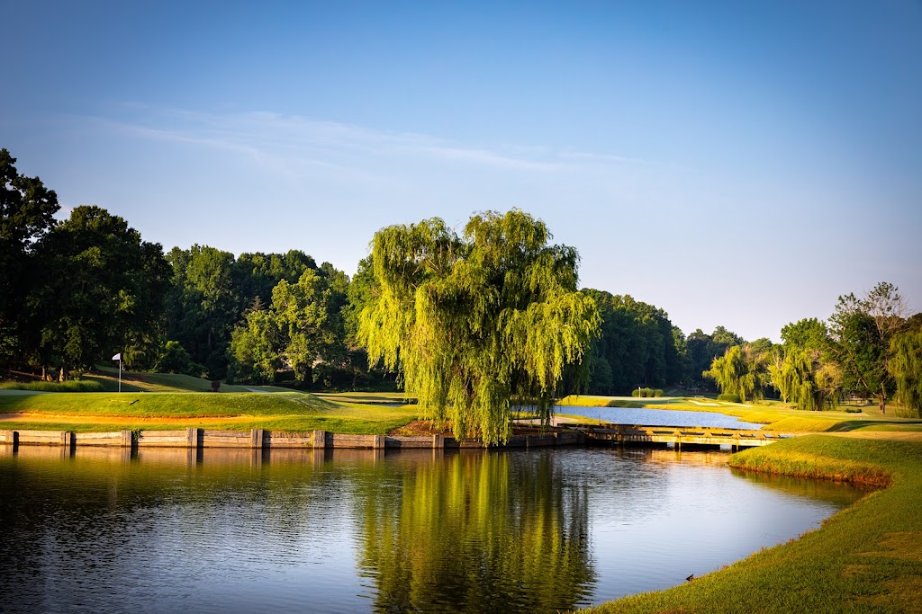 Panoramic view of a lush green golf course at The Cardinal by Pete Dye. Smooth