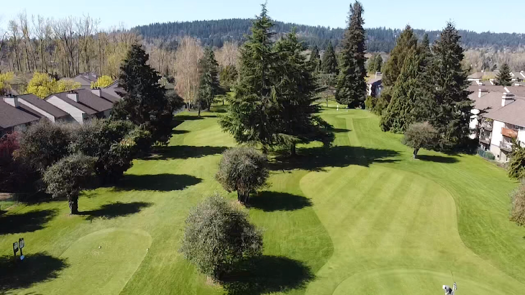 Panoramic view of a lush green golf course at The Children's Course. Smooth