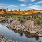 Panoramic view of a lush green golf course at The Club at ArrowCreek. Smooth