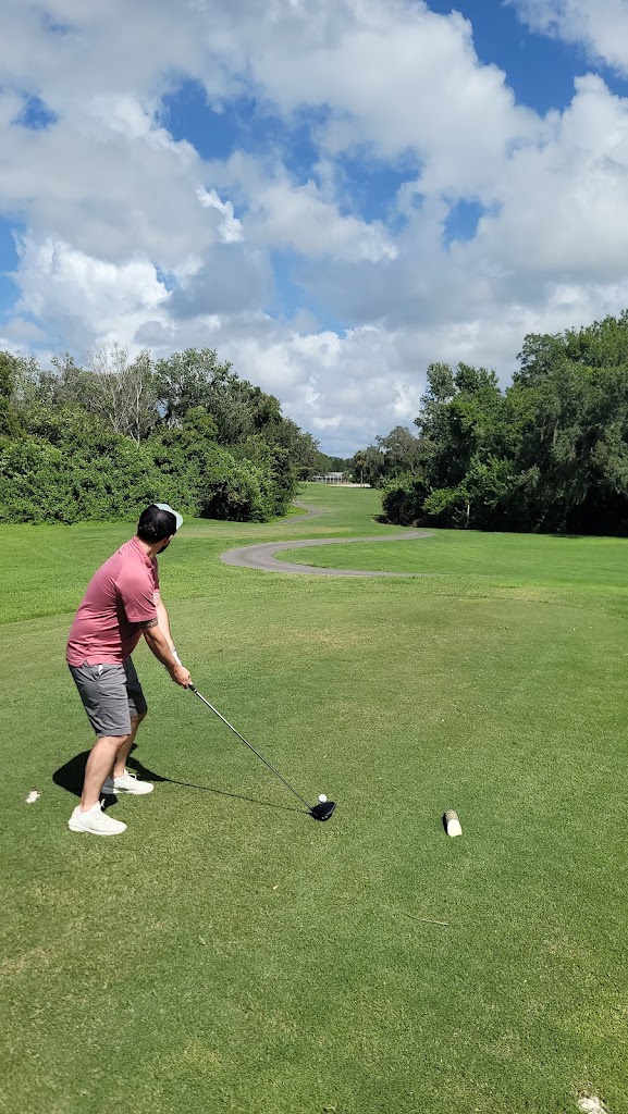 Panoramic view of a lush green golf course at The Club at River Wilderness. Smooth