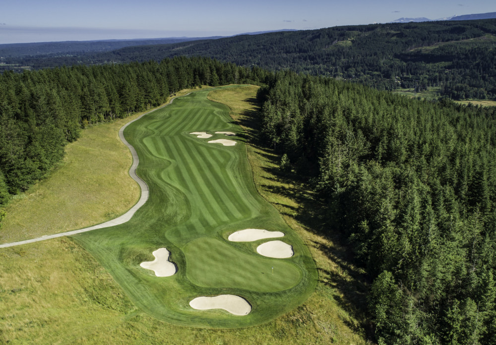 Panoramic view of a lush green golf course at The Club at Snoqualmie Ridge. Smooth