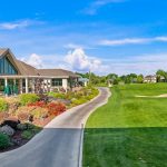 Panoramic view of a lush green golf course at The Club at SpurWing. Smooth