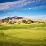 Panoramic view of a lush green golf course at The Club at Sunrise. Smooth