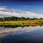 Panoramic view of a lush green golf course at The Clubhouse at Grand Traverse Resort and Spa. Smooth