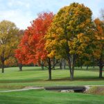 Panoramic view of a lush green golf course at The Country Club of Indianapolis. Smooth