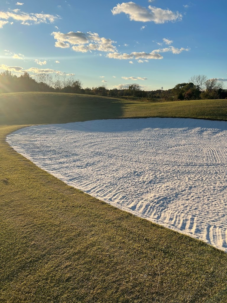 Panoramic view of a lush green golf course at The Courses at Andrews. Smooth