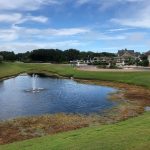 Panoramic view of a lush green golf course at The Currituck Club. Smooth