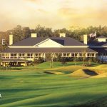 Panoramic view of a lush green golf course at The Dye Club at Barefoot Resort. Smooth