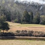 Panoramic view of a lush green golf course at The General Golf Course. Smooth