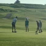 green grass with the flag in the hole.